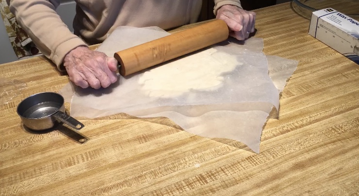 Pie dough being rolled.
